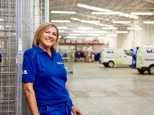 Zakenman in een depot met pakketten en palletten