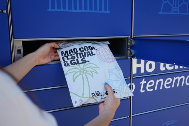 Person collecting Mad Cool Festival parcel from GLS smart lockers, parcel delivery and collection service with sustainable logistics