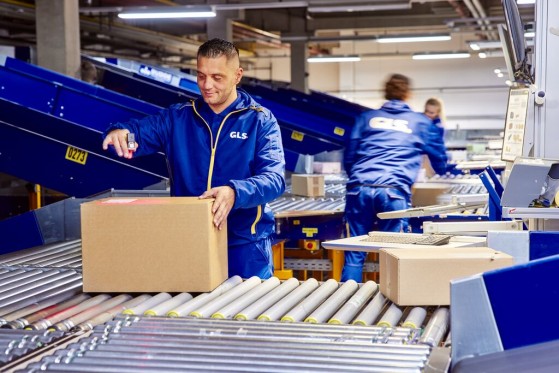 GLS worker taping a parcel in a warehouse