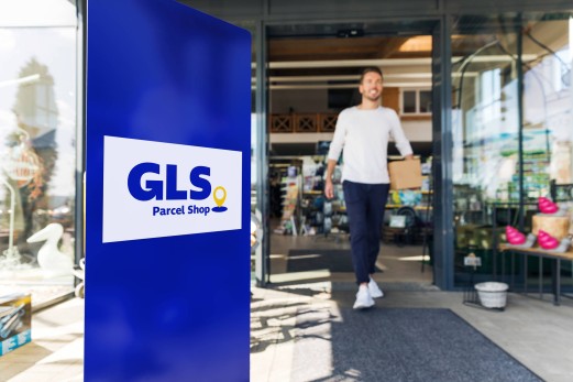 GLS delivery driver in front of ParcelShop