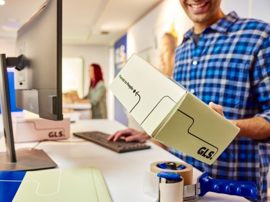 Young man opens a GLS parcel