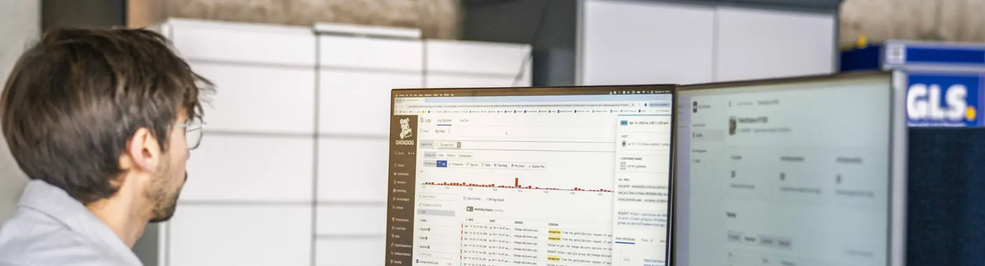 A man working on a computer with lines of code on the screen.